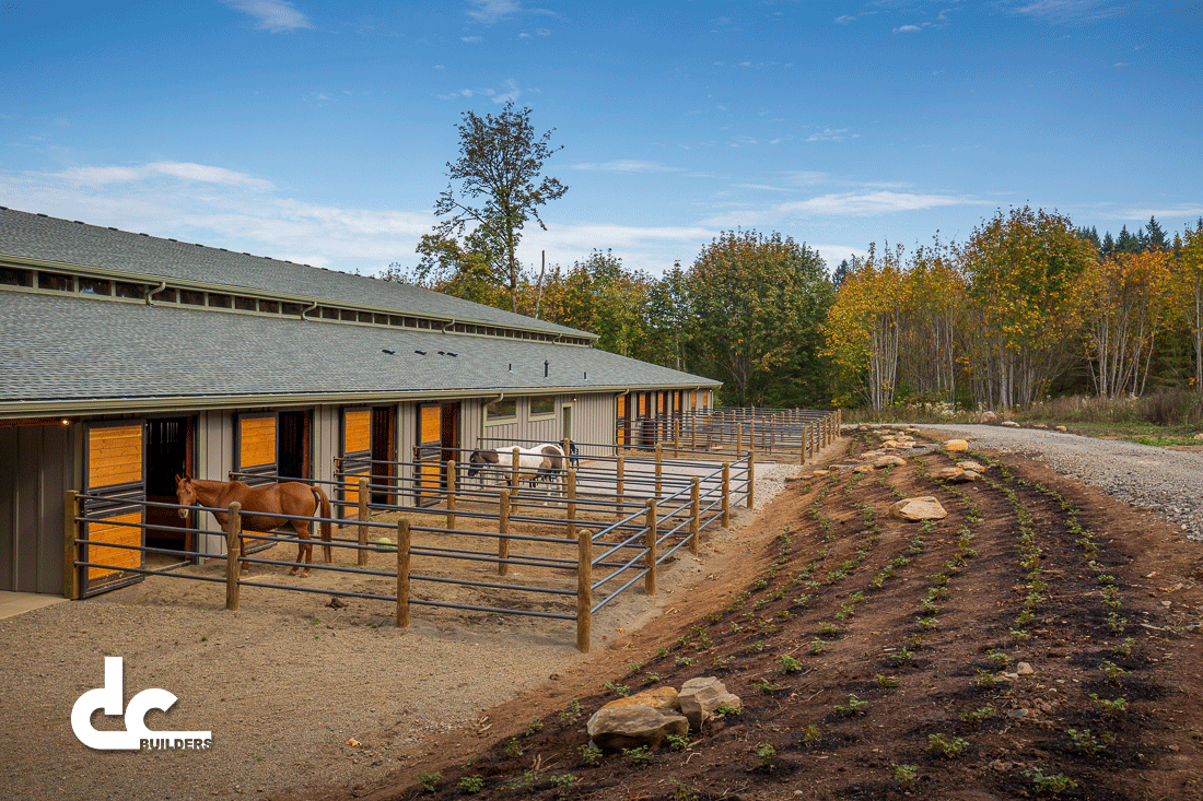 Classic Equine doors lead the horses from their stable to and open outdoor holding pen.